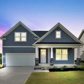 Two story single family home with blue siding and two car garages in the Cooper 3 plan with finished basement in DRB Homes Livingston Park