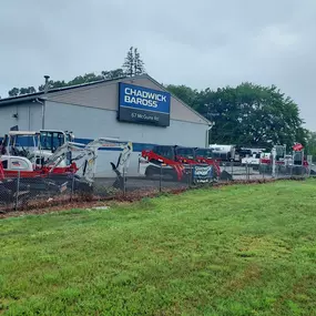 Exterior view of Chadwick-BaRoss showcasing heavy equipment including Takeuchi machines lined up