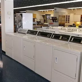 white washing machines and dryers on display