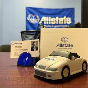 Desk in office with plush toy car and business card