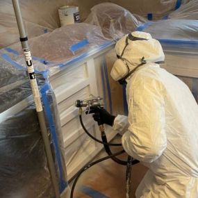 A Painter Working on Kitchen Cabinets