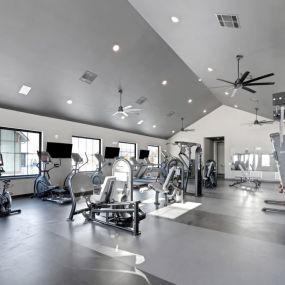 A fitness center with treadmill and other equipment