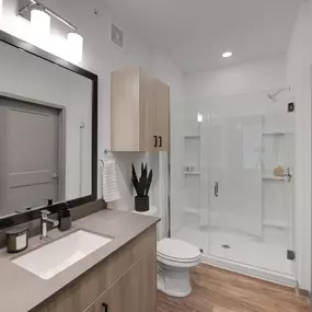 Bathroom with a large mirror and a toilet sink