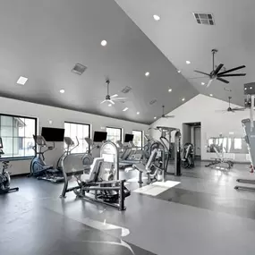 A fitness center with treadmill and other equipment