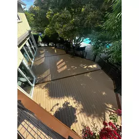 This beautifully painted wood deck features stylish cable railings, combining traditional craftsmanship with contemporary design elements for a stunning outdoor space.