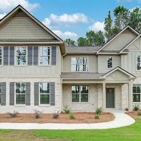 Tan brick 2 story home in DRB Homes Riverbend Overlook