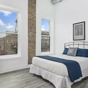 Exposed brick in spacious bedroom