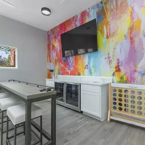 A break room with a table and chairs and a television