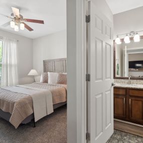 Bedroom with Lighted Ceiling Fans & Bathroom with Ample Counter Space