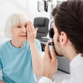 Senior woman covering her left eye during an eye exam