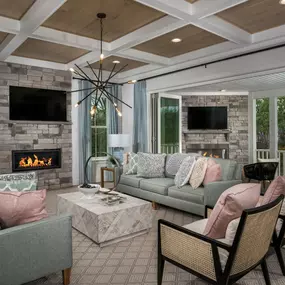 Family room with tray ceiling and fireplace in the Emory II model in the DRB Homes Hartland community