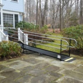 The front entrance of this Wilton, CT home is now wheelchair accessible with an Amramp modular wheelchair ramp.