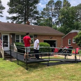 This ADA compliant ramp was installed for a Sentara PACE program participant in Portsmouth, VA, allowing the patient the ability to attend medical appointments and to take advantage of the social opportunities the program offers. Joe is seen here reviewing safety items with a caretaker.