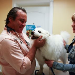 Dr. Anthony Krawitz greets a happy patient before beginning an annual wellness exam.