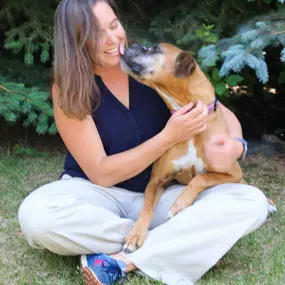 Dr. Anjuli Hein gladly accepts doggy kisses from her forever friend.