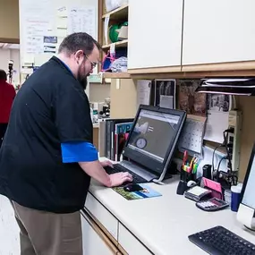 One of our vet techs is checking a patient’s medical records. We store our patients’ records and files digitally so that they are easy to access whenever our doctors need them.