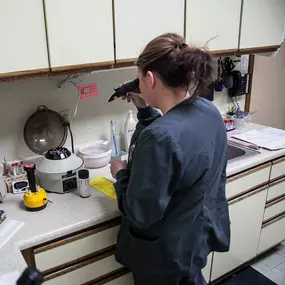 One of our doctors is using the tools in our in house laboratory to analyze a blood sample and make an accurate diagnosis.