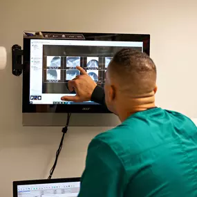 Pictured here is a team member reviewing dental x-rays of a patient.