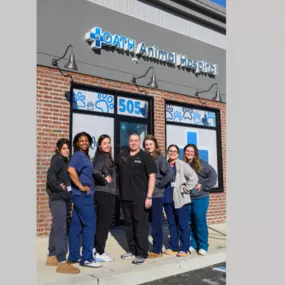 The Oath Animal Hospital vet team stands proudly outside the clinic in East Meadow, NY, smiling together as a united, compassionate 'dream team' dedicated to quality care.