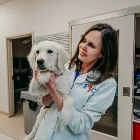 Dr. Prange cuddles with Riley during her annual wellness exam.