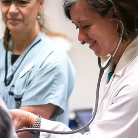 Dr. Bryant uses a stethoscope to listen to a patient’s heart and lungs.