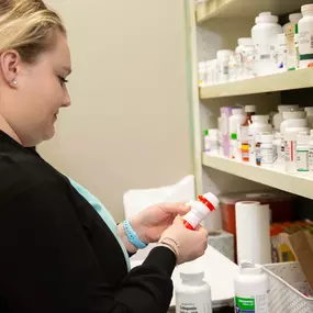 One of our wonderful team members carefully fills medication for a patient.