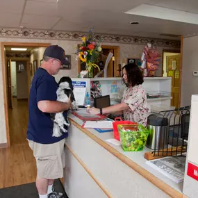 An adorable and eager pup is checking in for her annual wellness visit with one of our kind staff members!