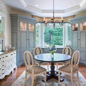 Blue Kitchen Cabinetry and Adjoining Dining Room