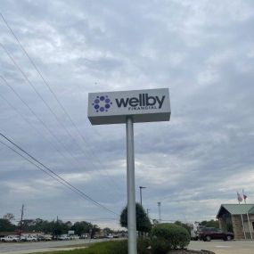 Exterior signage of Wellby Financial in Alvin