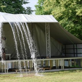 Canopies can protect performers and their equipment while playing from rain or daubery falling from the trees.