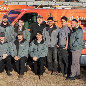 The North Star Heating & Air Conditioning company HVAC team. Standing in front of our orange work vans.
