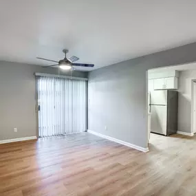 Living room with ceiling fan and faux wood flooring