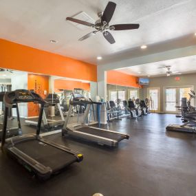 fitness center with treadmills and a weight room