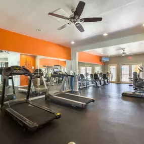 fitness center with treadmills and a weight room
