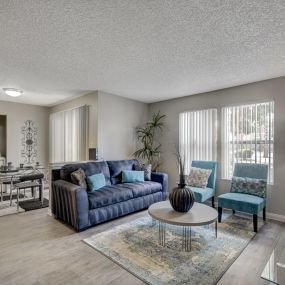 spacious living room with sofa and two chairs