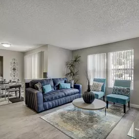 Spacious living room with sofa and two chairs