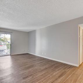 large living room with updated flooring and a sliding glass door