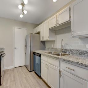 galley kitchen with white cabinets