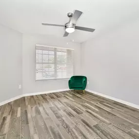 modern bedroom with ceiling fan and large window