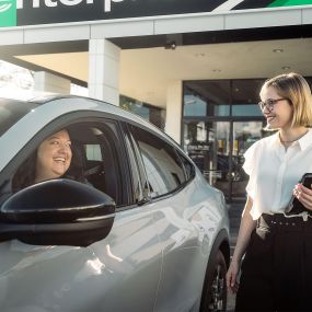 Enterprise customer service agent helping customer with electric car rental