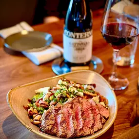 Our Steak Salad showcases succulent marinated skirt steak atop vibrant greens, roasted peppers, and tangy gorgonzola piccante, all drizzled with a charred tomato vinaigrette. Enjoy it alongside the striking 2018 Nervi Conterno Gattinara—a pairing that truly steals the spotlight!