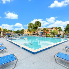 large swimming pool surrounded by lounge chairs