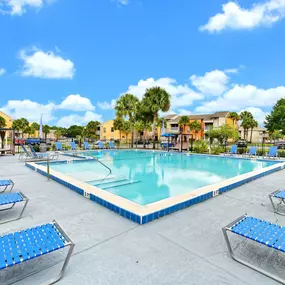 Large swimming pool surrounded by lounge chairs