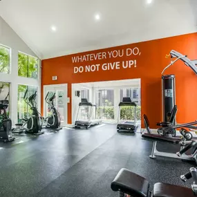 fitness center with vaulted ceilings and cardio equipment