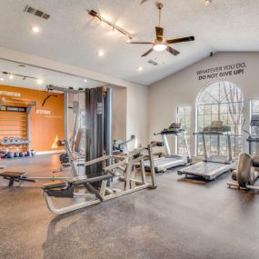 large fitness center with cardio equipment and weight machines