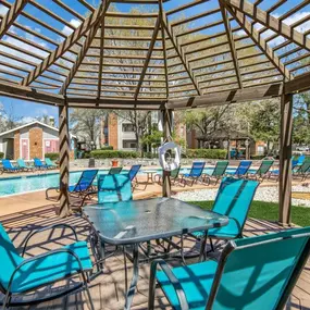 outdoor dining table next to the swimming pool