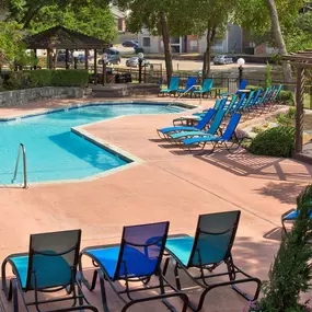 sunny outdoor swimming pool with lounge chairs