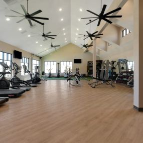 A spacious fitness center with treadmill and other equipment