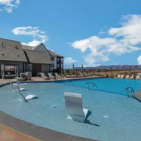 A large swimming pool with lounge chairs