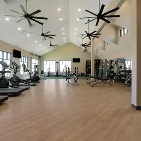 A spacious fitness center with treadmill and other equipment